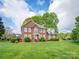 Traditional two-story brick home with a well-manicured front lawn and mature landscaping at 126 Pointer Se Ct, Concord, NC 28025