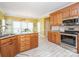 Bright kitchen with granite countertops, stainless steel appliances, and wooden cabinets at 126 Pointer Se Ct, Concord, NC 28025