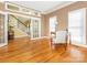 Bright and inviting living room featuring french doors, hardwood floors, and staircase access to the second level at 126 Pointer Se Ct, Concord, NC 28025
