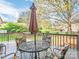 Outdoor seating area on wooden deck with an umbrella covered table and 4 chairs at 126 Pointer Se Ct, Concord, NC 28025