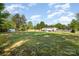 Large, private backyard featuring storage sheds, fencing, and mature trees, ideal for outdoor activities at 140 Misty Ln, Rockwell, NC 28138