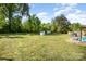 Large backyard featuring a gazebo, fire pit, storage sheds, and lush green grass for outdoor enjoyment at 140 Misty Ln, Rockwell, NC 28138