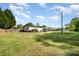Spacious backyard featuring a fenced perimeter, wooden deck, landscaping, and storage shed at 140 Misty Ln, Rockwell, NC 28138