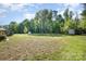 Expansive backyard featuring storage sheds and gazebo surrounded by mature trees, offering outdoor space at 140 Misty Ln, Rockwell, NC 28138