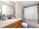 Bathroom with granite vanity, framed mirror, and shower-tub combo with patterned curtain at 140 Misty Ln, Rockwell, NC 28138