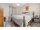 Cozy bedroom with warm wood accents, laminate floors, and a tranquil view of the side yard at 140 Misty Ln, Rockwell, NC 28138