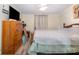 Comfortable bedroom features a neutral palette, laminate flooring, and a bright front window at 140 Misty Ln, Rockwell, NC 28138