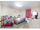 Charming bedroom with playful decor, laminate flooring, and a pink accent curtain at 140 Misty Ln, Rockwell, NC 28138