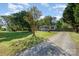 Home's exterior featuring a gravel driveway, lush lawn, and welcoming facade at 140 Misty Ln, Rockwell, NC 28138
