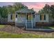 Charming single-story home features a cozy front porch perfect for enjoying peaceful evenings at 140 Misty Ln, Rockwell, NC 28138