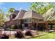 A beautiful backyard features a black metal fence surrounding the pool, brick accents, and mature landscaping at 1427 Doe Ridge Ln, Fort Mill, SC 29715