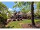 Lovely backyard with a manicured lawn, a fenced perimeter, a stone patio, and a pergola at 1427 Doe Ridge Ln, Fort Mill, SC 29715