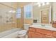Bathroom features a shower, bathtub, toilet, vanity with sink and a large window for natural light at 1427 Doe Ridge Ln, Fort Mill, SC 29715