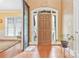 Inviting foyer with hardwood floors, a decorative front door with side lights, and neutral wall colors at 1427 Doe Ridge Ln, Fort Mill, SC 29715