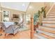 Spacious living room featuring hardwood floors, fireplace, a vaulted ceiling and a staircase at 1427 Doe Ridge Ln, Fort Mill, SC 29715