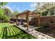 Inviting backyard setting featuring a pergola-covered patio and well manicured landscaping at 1427 Doe Ridge Ln, Fort Mill, SC 29715
