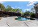 Inviting backyard pool with a waterfall feature, mature privacy landscaping, and an adjacent lounge area at 1427 Doe Ridge Ln, Fort Mill, SC 29715