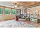 Bright sunroom with wood ceiling, brick wall, many windows, and versatile setup for work and play at 1427 Doe Ridge Ln, Fort Mill, SC 29715