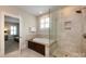 Well-lit bathroom featuring a separate shower and tub and neutral tiling at 1550 Matthew Mcclure Cir, Davidson, NC 28036