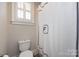 Clean bathroom featuring a stylish shower curtain with white tiles and simple fixtures at 1550 Matthew Mcclure Cir, Davidson, NC 28036