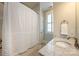 Bathroom featuring marble countertop, decorative shower curtain and window at 1550 Matthew Mcclure Cir, Davidson, NC 28036
