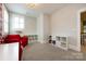 Spacious bedroom with white shelving units and a comfortable red chair at 1550 Matthew Mcclure Cir, Davidson, NC 28036