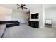 Neutral bonus room with a large TV, a comfy gray couch, and neutral carpet at 1550 Matthew Mcclure Cir, Davidson, NC 28036