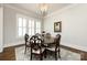 Bright dining room featuring a round table with seating for six, modern chandelier, and hardwood floors at 1550 Matthew Mcclure Cir, Davidson, NC 28036