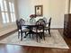 Elegant dining room with a round wood table, seating for eight, and light colored rug at 1550 Matthew Mcclure Cir, Davidson, NC 28036