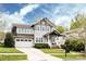 Charming two-story home featuring a well-manicured lawn, two-car garage, and inviting front porch at 1550 Matthew Mcclure Cir, Davidson, NC 28036