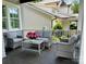 Relaxing front porch with gray wicker furniture and a small table, perfect for enjoying the outdoors at 1550 Matthew Mcclure Cir, Davidson, NC 28036
