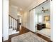 Elegant hallway featuring hardwood floors, a staircase, and an office featuring a sliding barn door at 1550 Matthew Mcclure Cir, Davidson, NC 28036