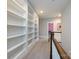 Hallway featuring custom built-in bookshelves and neutral carpeting at 1550 Matthew Mcclure Cir, Davidson, NC 28036