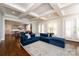 Bright and spacious living room featuring a blue sofa, open to the kitchen and dining area, and coffered ceilings at 1550 Matthew Mcclure Cir, Davidson, NC 28036