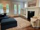 Bright living room with fireplace, built-in shelving, and French doors offering natural light at 1550 Matthew Mcclure Cir, Davidson, NC 28036
