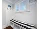 Cozy mudroom features a built-in bench with storage and coat hooks, and a window with white shutters at 1550 Matthew Mcclure Cir, Davidson, NC 28036