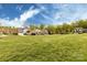 Picturesque neighborhood featuring well-manicured lawns, mature trees, and sidewalks, and a large grassy common area at 1550 Matthew Mcclure Cir, Davidson, NC 28036