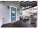 Inviting front porch with comfortable seating, stylish decor, and a welcoming entrance with a blue door at 1550 Matthew Mcclure Cir, Davidson, NC 28036