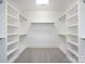 Spacious walk-in closet with built-in shelving and neutral carpeting at 1550 Matthew Mcclure Cir, Davidson, NC 28036