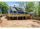 Enjoy a large backyard with a wooden deck on a charming blue house, perfect for outdoor gatherings at 166 Franklin Nw Ave, Concord, NC 28025