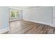 Bright bedroom featuring hardwood floors, neutral walls, and a large window with exterior views at 166 Franklin Nw Ave, Concord, NC 28025