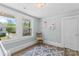 Bedroom with wood floors, bright blue walls, double window, and chair creates cozy relaxing space at 166 Franklin Nw Ave, Concord, NC 28025