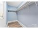 Walk-in closet featuring ample shelving and storage space at 166 Franklin Nw Ave, Concord, NC 28025