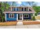 Charming blue two-story home with brown shutters and a well-manicured lawn offers great curb appeal at 166 Franklin Nw Ave, Concord, NC 28025