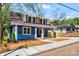 Charming home with blue siding, wooden shutters, inviting front porch, and well-manicured landscaping at 166 Franklin Nw Ave, Concord, NC 28025