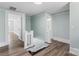 Bright hallway with hardwood floors and blue walls, showcasing staircase and doorways to other rooms at 166 Franklin Nw Ave, Concord, NC 28025