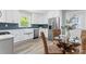 Bright kitchen featuring modern stainless steel appliances and a breakfast table at 166 Franklin Nw Ave, Concord, NC 28025