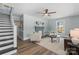 Bright living room with a decorative fireplace, modern ceiling fan, and sleek, light-colored walls and trim at 166 Franklin Nw Ave, Concord, NC 28025
