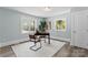 Office features natural light and neutral colors, creating a bright workspace with hardwood floors at 166 Franklin Nw Ave, Concord, NC 28025