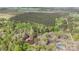 An aerial shot highlights the home's location nestled in a lush, wooded area with a tranquil pond nearby at 170 Dusty Loop Dr, Mount Gilead, NC 27306